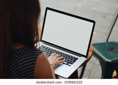 Woman Back View Working On Laptop Sitting In A Coffee Shop