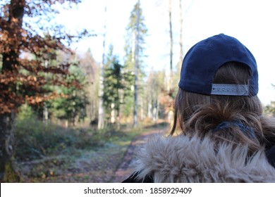 Woman From Back Walking In The Forest, With Cap, Faux Fur Coat