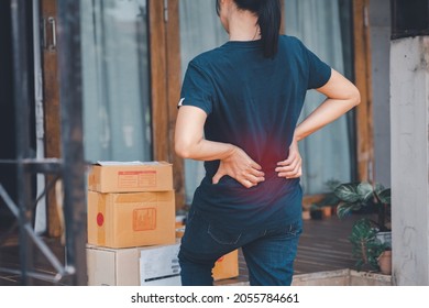 Woman With Backache While Lifting Box, Touching Back With Hand.