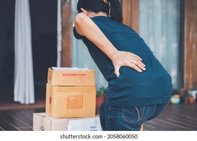 Woman With Backache While Lifting Box, Touching Back With Hand.