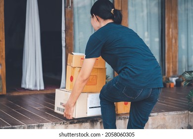 Woman With Backache While Lifting Box, Touching Back With Hand.