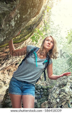 Woman with backpack traveling in the mountains.