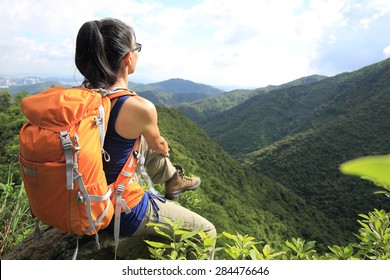 Woman Backpacker Enjoy The View At Mountain Peak Cliff