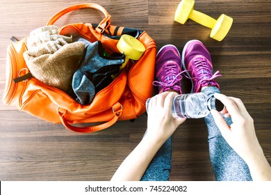 Woman with bag and fitness equipment - Powered by Shutterstock