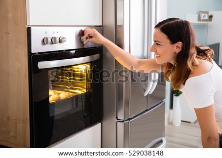 Woman Baking In Oven