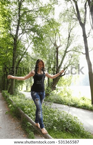 Similar – Beautiful young woman smiling and walking happy on the park outdoors