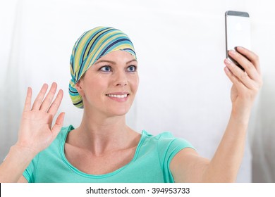 Woman, Bald From Chemotherapy, Doing A Selfie With Cell Phone  