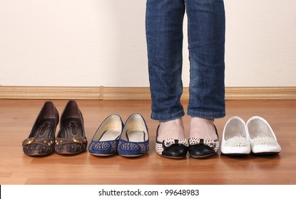 Woman In Ballet Flat Shoes On Wooden Background