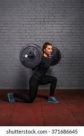 Woman With Barbell Doing Split Squat Or Lunge