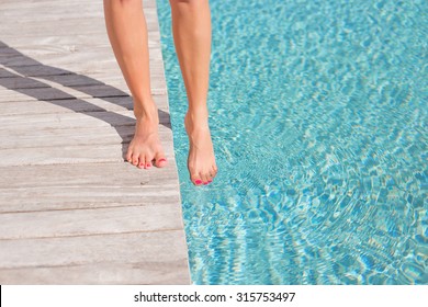 Woman With Bare Feet By The Pool