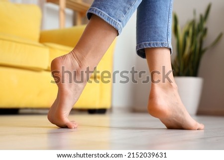 Woman with bare feet at home, closeup