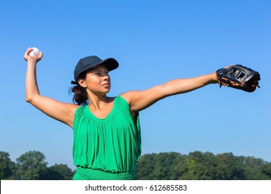 Woman With Baseball Glove And Cap Throwing Baseball Outdoors