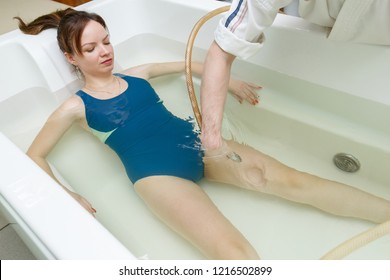 Woman In Bath During Hydromassage In Beauty Spa Salon. Underwater Hydrotherapy Massage Procedure