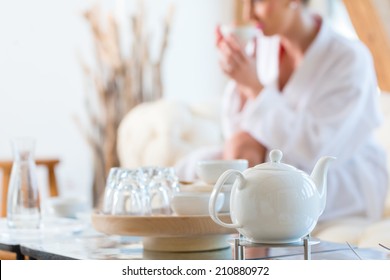 Woman In Bath Robe Drinking Tea In Wellness Spa Relaxation Room