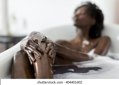 Woman bathing in a tub full of foam