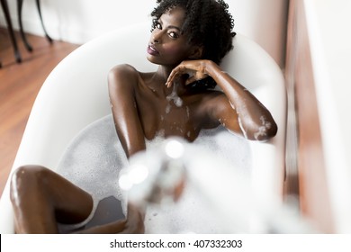 Woman Bathing In A Tub Full Of Foam