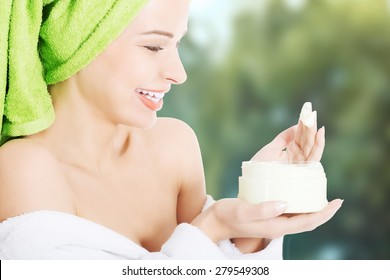 Woman In Bathrobe With Body Lotion.