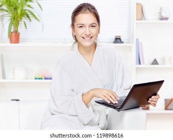 Woman In Bathrobe At Home With Computer