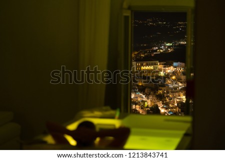 woman in the bathroom at the hotel enjoying the view of the night city