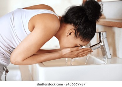 Woman, bathroom and sink for washing face, skincare and beauty for morning routine or wellness in home. Female person, tap or girl cleaning with water in house for natural facial treatment in basin - Powered by Shutterstock