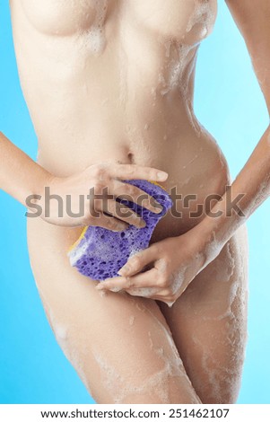 Woman in bathroom with wisp of bast on blue background