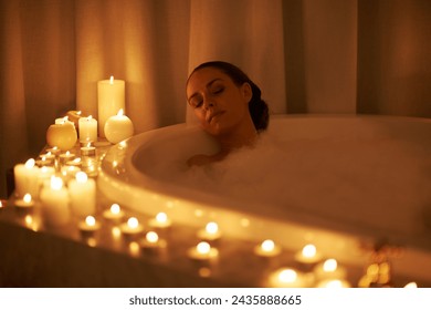 Woman, bathtub and candles for relax treatment at spa or cleaning routine with bubbles for washing, hygiene or wellness. Female person, calming and stress relief skincare with peace, tub or comfort - Powered by Shutterstock