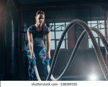 Woman With Battle Rope Battle Ropes Exercise In The Fitness Gym. CrossFit.