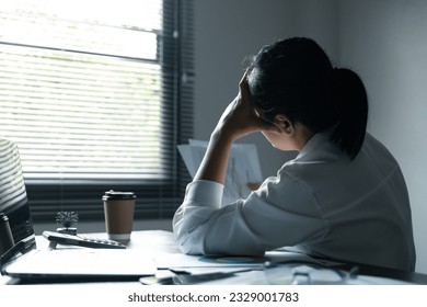 A woman battles depression and stress in her workplace, highlighting the challenges faced by professionals. This image captures the impact of mental health on employees in a corporate environment. - Powered by Shutterstock