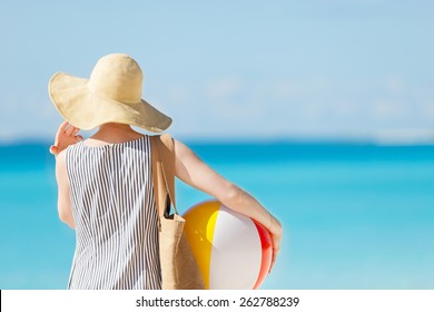 Woman At The Beach Back View Holding Beach Ball And Bag