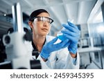 Woman, beaker or scientist in laboratory for science innovation, life expectancy or antiaging medicine. Futuristic, medical or healthcare biologist with chemistry liquid in research or examination