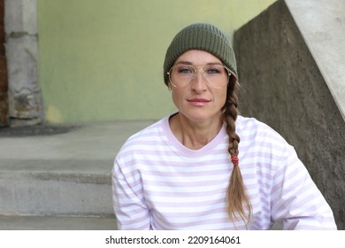 Woman Bearing Beanie, Retro Eyeglasses And Braided Hair 