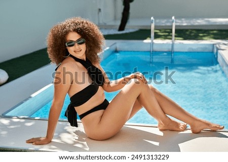 Similar – Brunette surfer woman in bikini standing with surfboard