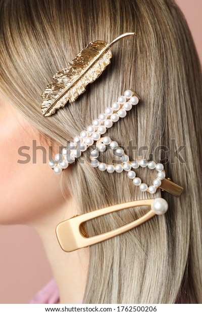 Woman with\
beautiful different hair clips,\
closeup