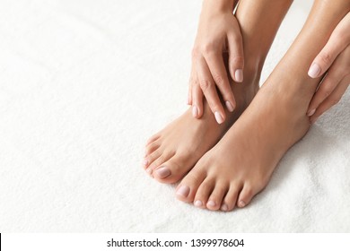Woman with beautiful feet on white towel, closeup. Spa treatment - Shutterstock ID 1399978604