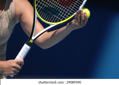 A Woman With Beautiful Hands Is Holding A Tennis Ball And Racquet Preparing For Her Serve.