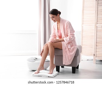 Woman With Beautiful Legs Sitting Near Foot Bath At Home, Space For Text. Spa Treatment