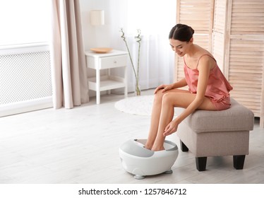 Woman With Beautiful Legs Using Foot Bath At Home, Space For Text. Spa Treatment