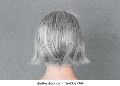 Woman with beautiful natural gray hair, from behind.