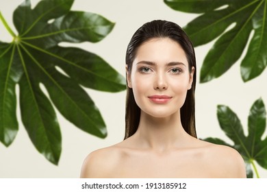 Woman Beauty Face Natural Make Up. Green Leaf Cosmetic Skin Care. Wet Hair Perfect Model In Tropical Leaves Nature Background