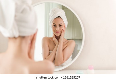 Woman With Beauty Face Touching Healthy Facial Skin Portrait. Beautiful Smiling Asian Girl Model With Natural Makeup Touching Glowing Hydrated Skin. Skin Care.