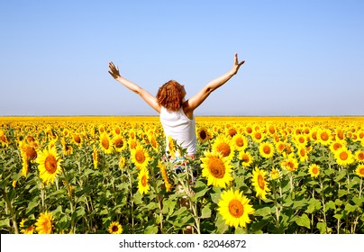 Woman In Beauty Field With Sunflowers