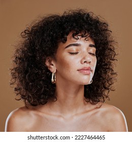 Woman, beauty and freckles, curly hair and facial treatment, makeup and body care aesthetics, shine or glow on studio background. Young model, melasma face and natural cosmetics, skincare or wellness - Shutterstock ID 2227464465