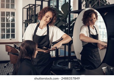 Woman, beauty salon and cutting hair of customer for keratin treatment, haircare and professional for hairstyle. Hairdresser, cosmetologist and hairstylist with client for grooming, service and care. - Powered by Shutterstock