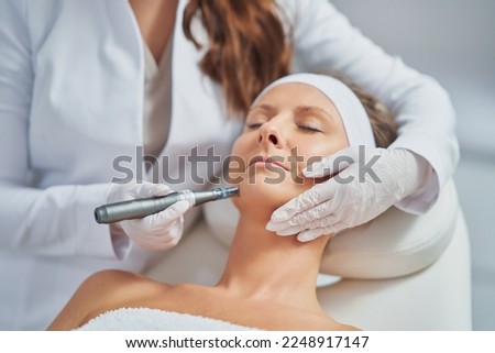 Woman in a beauty salon having needle mesotherapy treatment