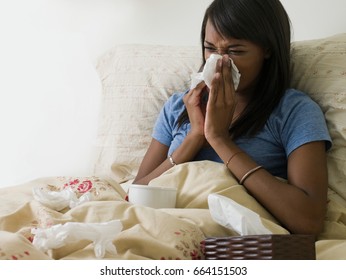 Woman in bed with cold - Powered by Shutterstock