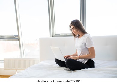 Woman In Bed With Laptop On Legs