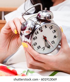 Woman In A Bed Setting The Alarm Clock