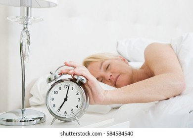 Woman In Bed, Turning Off Alarm