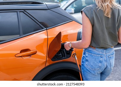 Woman From Behind Charging The Electric Car