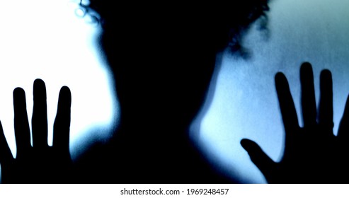 Woman behind diffused glass feeling trapped. Mental illness concept